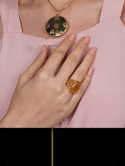 A close-up of a large, intricately carved jade pendant and matching ring. This highlights the unique character and artistry of my gemstone pieces.