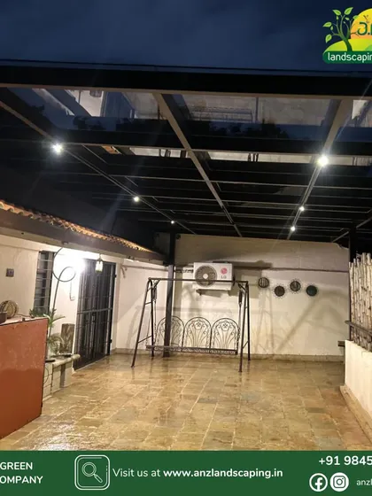 A completed view of the toughened glass pergola at Mr. Hemant's residence at night. The integrated lighting creates a warm and inviting atmosphere, making it a perfect spot for evening relaxation.