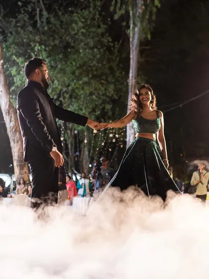 A dreamy couple's dance in the clouds, with dry ice smoke creating a magical effect as they walk hand-in-hand.