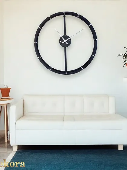 The creative round wall clock, shown in a living room setting to illustrate its scale and modern appeal.