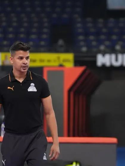 A moment of observation from the sidelines during a training session in the Mumbai arena.