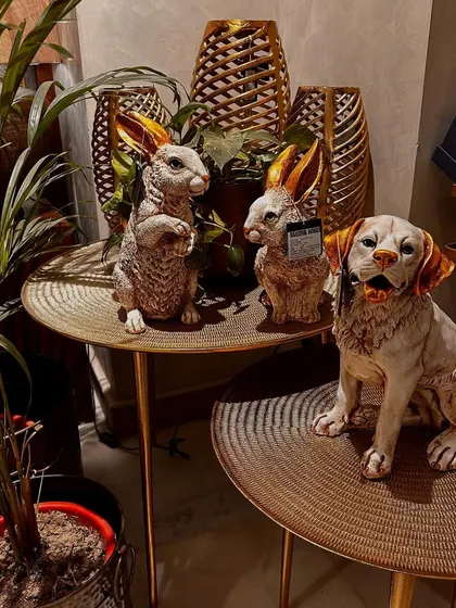 Even our animal sculptures get into the festive spirit. These adorable resin bunnies and dog add a whimsical touch to our Christmas display.