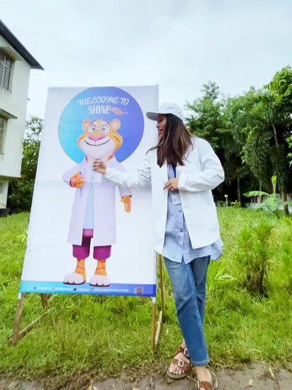 Posing with the mascot for the 'SHINE' science outreach program.