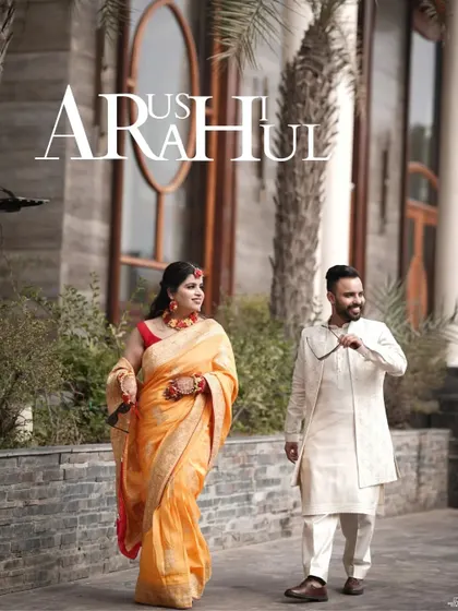 A stylish shot of the couple walking together at their Haldi venue, their coordinated outfits looking elegant against the modern architecture.