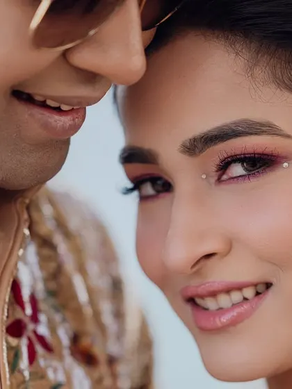 Another intimate close-up, highlighting the bride's stunning makeup and the groom's sequined jacket.