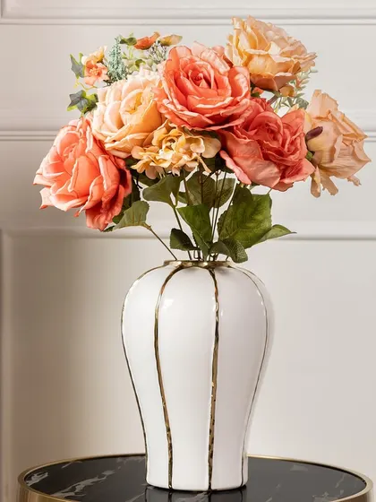 A similar artificial peony bouquet, this one featuring warm, sunset-orange tones. It's a vibrant arrangement that brings a feeling of warmth and joy to any room.