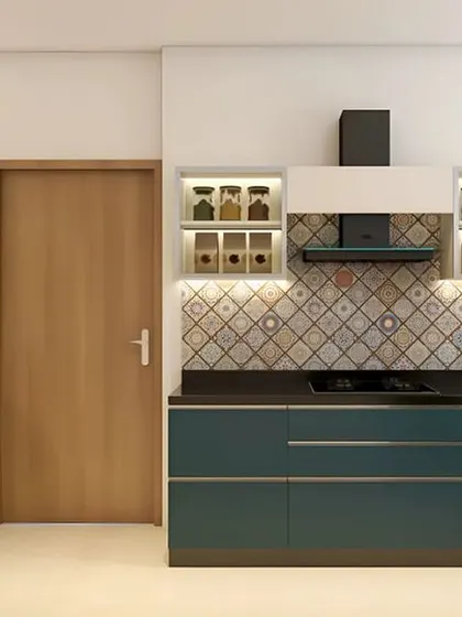 Another view of a teal and white kitchen, this time showing handleless drawers and illuminated upper cabinets. The geometric backsplash tile adds texture and visual interest.