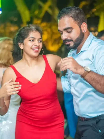 A vibrant red dress perfect for a Christmas Salsa night. The festive attire adds to the magical atmosphere.
