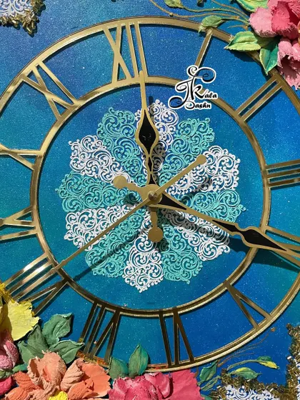 A macro shot of the clock's center, with a two-toned blue and white stencil design that mimics ocean waves.