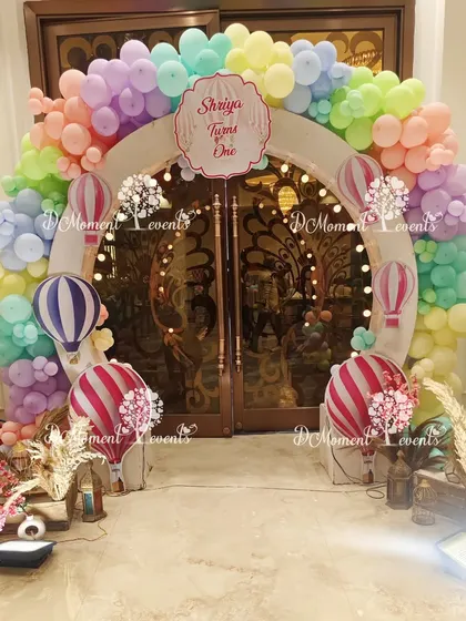 A closer look at the charming hot air balloon entrance arch, showcasing the detailed cutouts and the soft, inviting color palette.