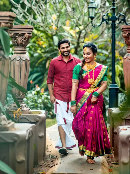 A candid walking shot from the same traditional photoshoot, showcasing the elegance of the coordinated outfits in a beautiful garden setting.