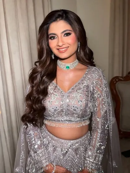 Voluminous hair and a stunning glam look for her reception. We focused on creating dramatic, beautiful eyes and glowing skin to match her intricately detailed silver lehenga.