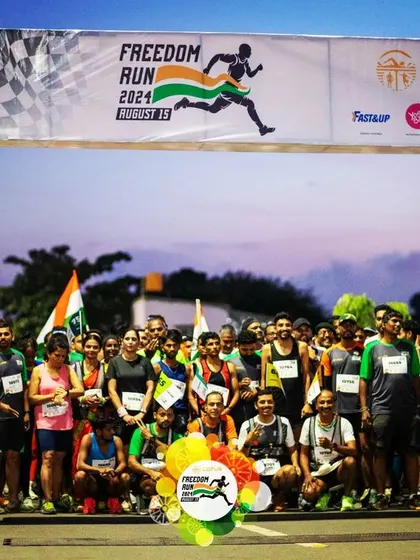 The starting gate of the Freedom Run 2024, with runners lined up and ready to begin their journey at dawn.