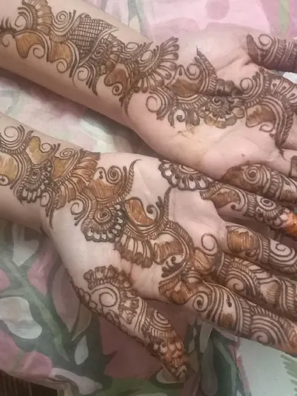 An elegant non-bridal mehendi design that trails up the arm, perfect for someone who wants a noticeable but not full-coverage look.