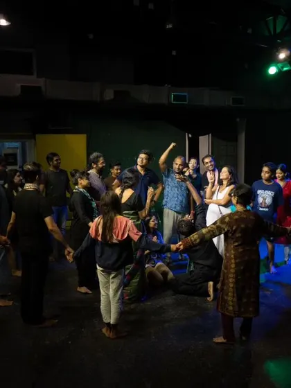 A wide shot of a community circle during a workshop, showing how our entire space can be used for interactive and immersive activities.