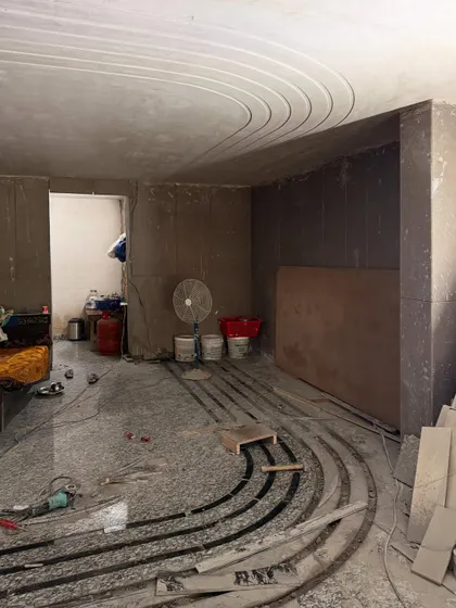 The process of creating a continuous inlay design, from the 2D plan to the messy on-site work, showing how the pattern is meticulously laid on the floor and ceiling.
