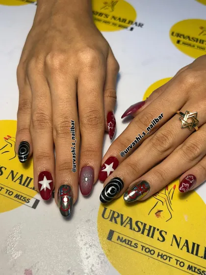 A retro and fun set inspired by Coca-Cola. I combined the iconic logo on a chrome nail with bold red, stars, and graphic black and white swirls for a pop-art vibe.