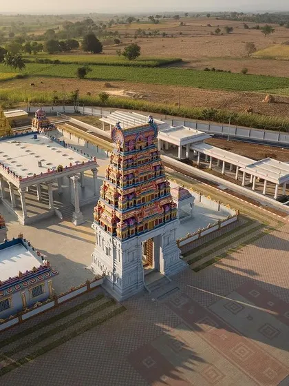 This high-angle shot captures the intricate layout of the temple courtyard and the surrounding structures, designed in collaboration with traditional temple Sthapatis.