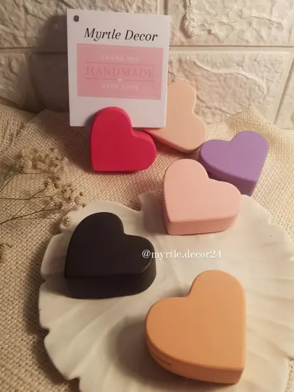 A collection of our heart-shaped photo holders in various pastel and bold colors. They are one of our bestselling items, perfect for gifting or displaying your own cherished memories.