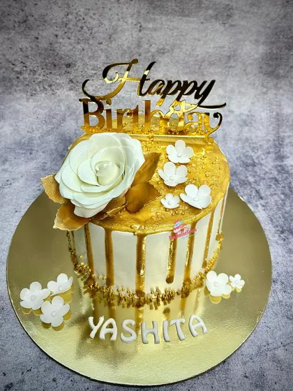 The full view of the white and gold drip cake, a simple yet stunning design for an elegant birthday celebration.