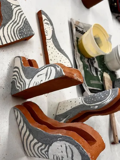 The ceramic pieces for 'Confrontation' after being glazed and fired, laid out before assembly.