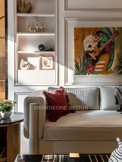 A close-up of the curated details in our classic living room project. The custom shelving holds carefully selected decor, while the vibrant artwork and plush cushions add personality and warmth to the sophisticated space.