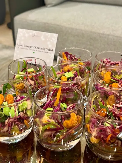 Individual glasses of Asian Chopped Crunchy Salad, a fresh and zesty starter for the "Eat, Play, Love" dinner.