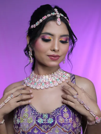 A close-up of the eye makeup, featuring a blend of yellow, pink, and purple shades for a sunset-inspired effect.