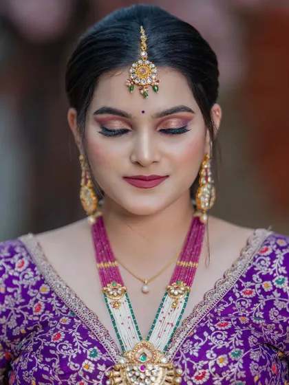 A close-up of a bride with her eyes closed, showcasing the soft and expertly blended eyeshadow in shades of purple and gold. This highlights the precision of my makeup artistry.