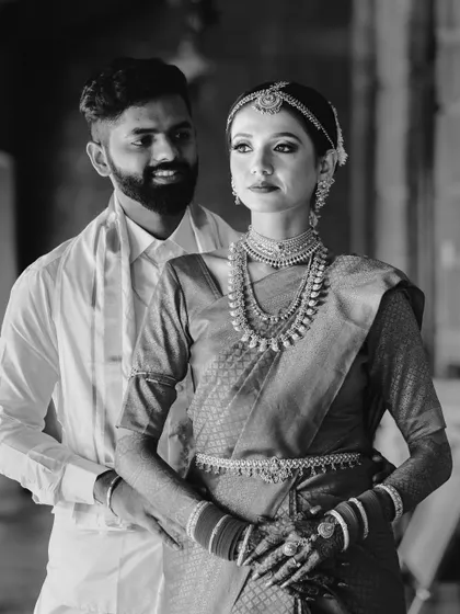 A classic black and white portrait of the couple in their South Indian wedding attire, exuding grace and elegance.
