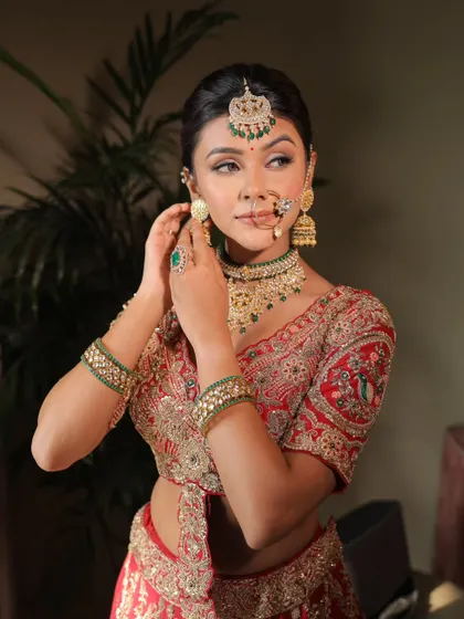 A close-up shot of a guest getting her earrings on. The glittery eyes and radiant skin are the focus of this beautiful makeup look.
