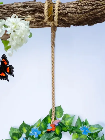 A detail shot of a nature-themed studio prop. This leafy wreath with butterflies is used to create an enchanting backdrop for newborn photos.