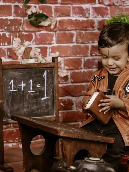 A gallery of our popular school and library theme. These images show the versatility of the brick wall backdrop, mini school desk, globe, and book props for creating a variety of scholarly and classic portraits.