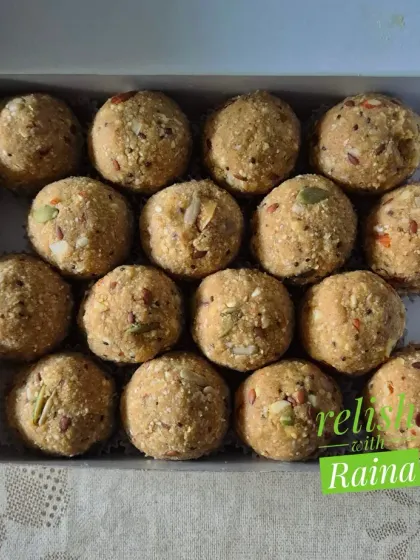 A close-up of the Sattu Makhana Laddoos, showing the texture from the seeds and nuts mixed into the flour base.