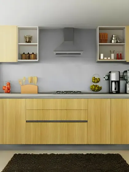 A simple and bright U-shaped kitchen with light wood cabinets and open shelving. Red pendant lights add a pop of color to the neutral space.