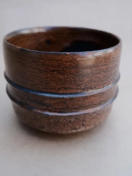 Another angle of the crackle glaze tea bowl. The simple, grooved lines around the middle provide a subtle decorative detail and a pleasant tactile feel.