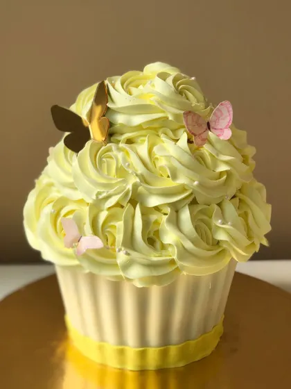 A giant cupcake that's perfect for a cake smash photoshoot or as a fun, unique birthday cake.