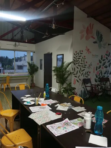 A view of the workshop space after a creative session. You can see the art supplies on the table and the inspiring, plant-filled environment we work in. I make sure you have everything you need to feel creative.