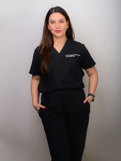A doctor's portrait in scrubs against a white background. This is an authentic look that is perfect for hospital websites or healthcare-related publications.