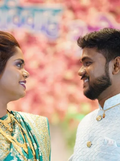 A happy, close-up shot of the couple. Her makeup is glowing and his smile is bright.