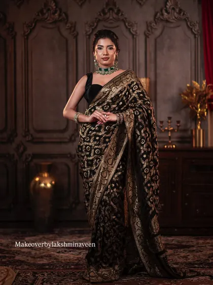 This elegant look with a black saree and green jewelry is a perfect example of classic styling that I teach my students.