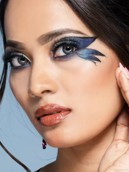 A direct-to-camera beauty shot, showcasing a creative graphic eyeliner look.