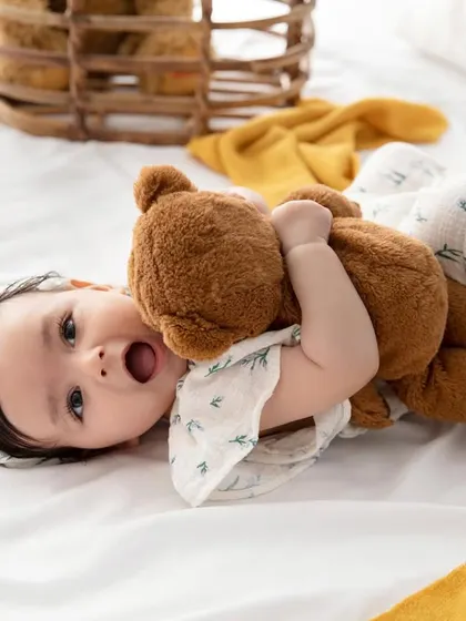 Cuddles with a favorite teddy bear. Props can bring out a baby's personality and create such sweet, story-filled images.