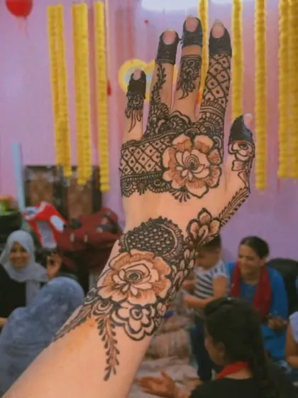 Another view of my popular floral and geometric design, taken at a family function. The henna looks beautiful against the festive background.