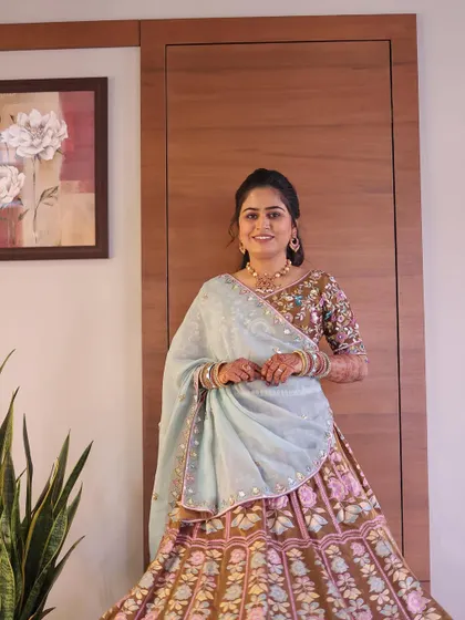 A beautiful, soft makeup look for a pre-wedding event. The earthy tones of the lehenga are complemented by natural, glowing makeup.