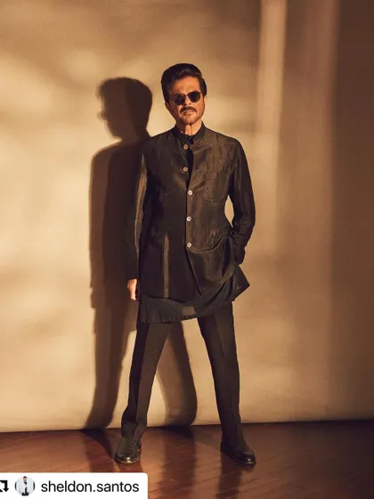 A full-length shot of Anil Kapoor looking dapper. The hair is styled with precision to complete the sharp, formal look.