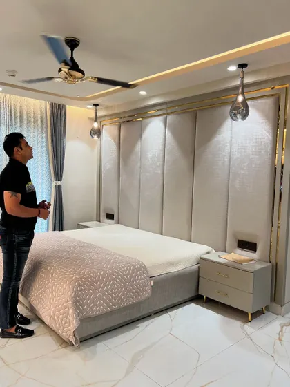 Another view of the master bedroom with the gold-trimmed headboard, showing my final inspection.
