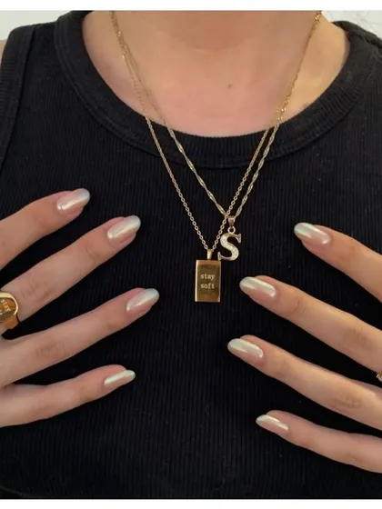 A close-up of our beautiful pearl chrome nails. This effect gives a clean, minimalist look with a high-fashion, iridescent shine that catches the light perfectly.