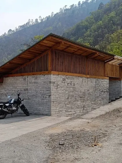 **Angling Centre, Pancheshwar:** The building uses a combination of local stone for the solid base and a lighter wooden structure above. This approach grounds the building in its site while allowing for open, panoramic views.