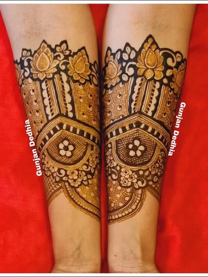 The beginning of an engagement mehendi design, featuring beautiful lotus bands on the arms. This creates a lovely cuff effect.